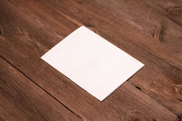 Sheet of paper on a wooden background — Stock Photo, Image