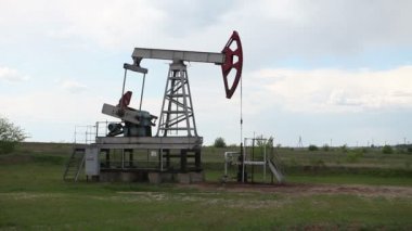 yağ pompası petrol pompalıyor. Bulutlu gökyüzü.