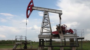 yağ pompası petrol pompalıyor. Bulutlu gökyüzü.