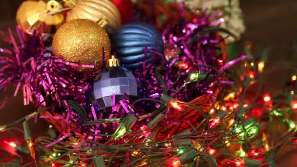 Christmas balls and garland flashing tangled on the floor — Stock Video