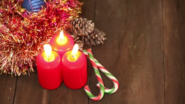 Decorações de Natal. Queimando velas e brinquedos no fundo de guirlandas piscando . — Vídeo de Stock