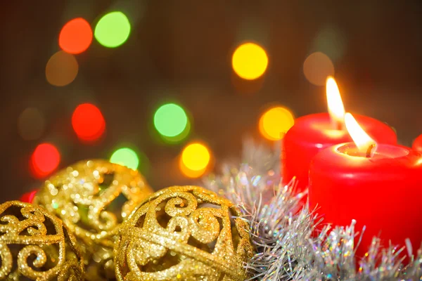 Three burning candles and golden balls. Christmas still life Stock Photo