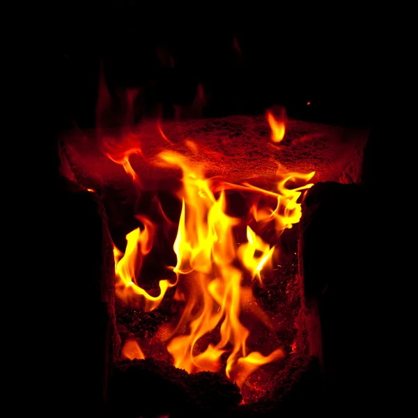 Flames erupt from the combustion chamber of the furnace, on a black background — Stock Photo, Image