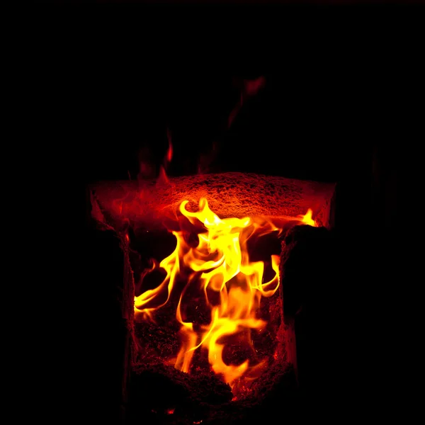 Flames erupt from the combustion chamber of the furnace, on a black background — Stock Photo, Image