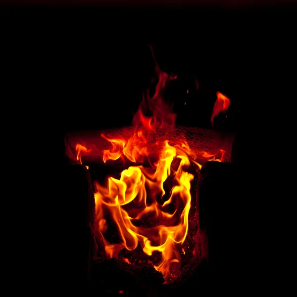 Flames erupt from the combustion chamber of the furnace, on a black background — Stock Photo, Image