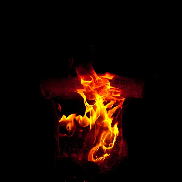 Flames erupt from the combustion chamber of the furnace, on a black background — Stock Photo, Image