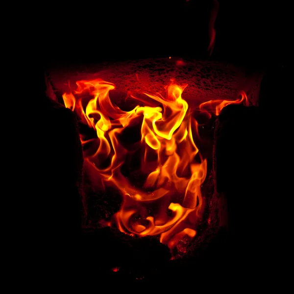 Flames erupt from the combustion chamber of the furnace, on a black background — Stock Photo, Image