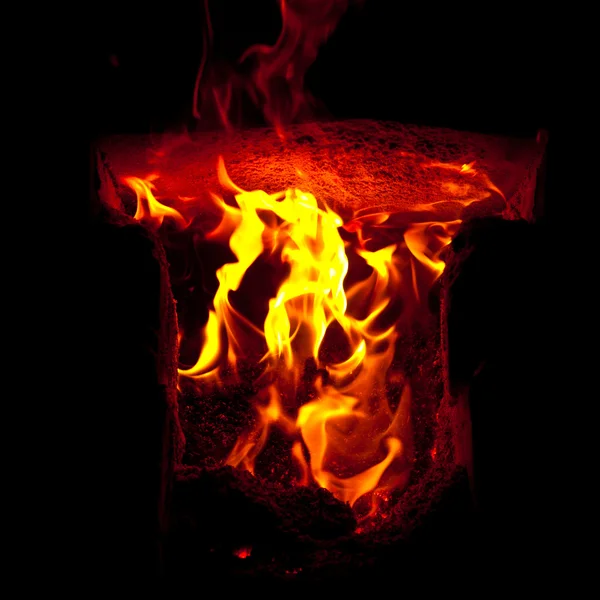 Flames erupt from the combustion chamber of the furnace, on a black background — Stock Photo, Image