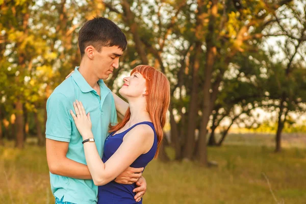 Young couple hugging in forest outdoors — Stock Photo, Image