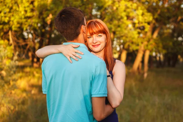 Young couple hugging in forest outdoors — Stock Photo, Image