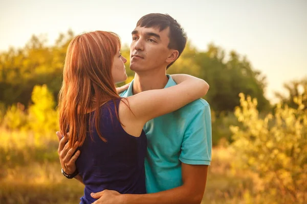 Young couple hugging in forest outdoors — Stock Photo, Image