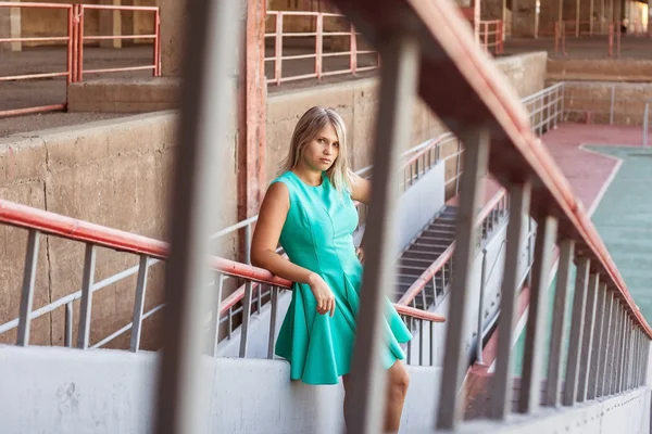 Joven hermosa chica en un vestido de novia de color turquesa posando en las escaleras —  Fotos de Stock