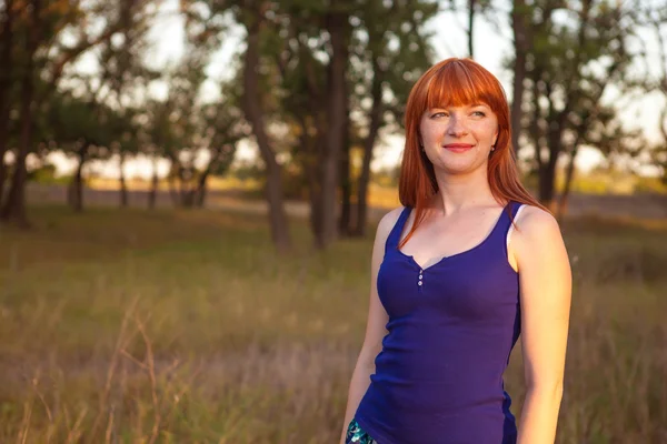 Beautiful red-haired girl posing in the outdoors — Stock Photo, Image