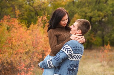 Kız elinde adam. Sevgi dolu bir çift sonbaharda yürüyüş