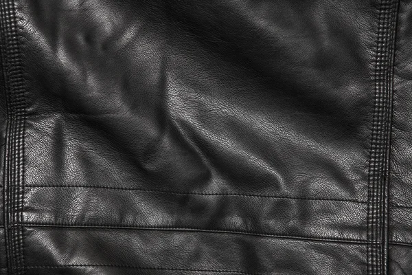 Black leather background in the folds — Stock Photo, Image