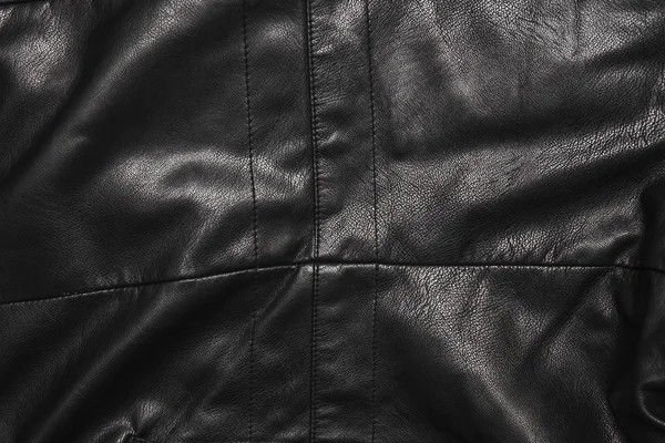 Černá kožená pozadí v záhybech — Stock fotografie