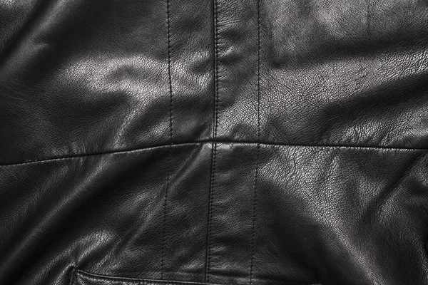 Black leather background in the folds — Stock Photo, Image