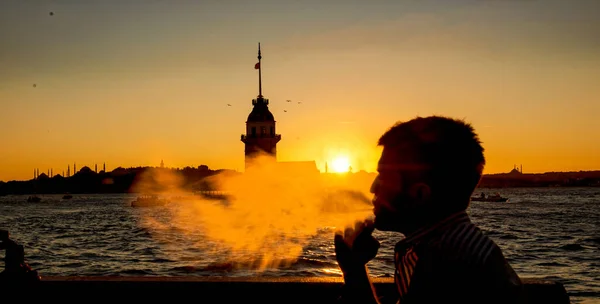 Man smoking in a ferry boat at sunrise over Bosphorus, Istanbul — Stock Photo, Image
