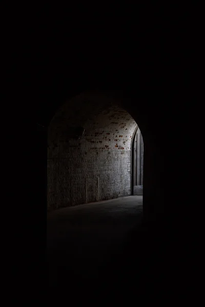 Light at the end of dark brick corridor — Stock Photo, Image