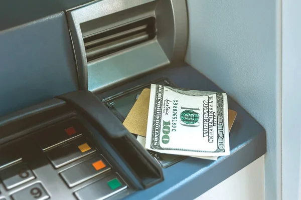 Money with a bank card is on the ATM