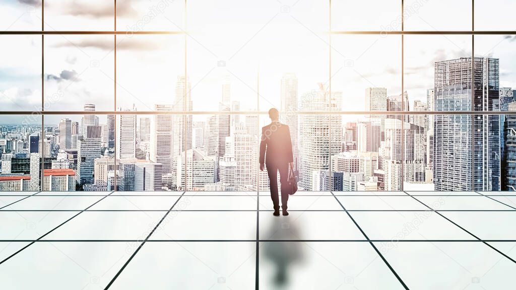 Businessman standing in a building looking at the city