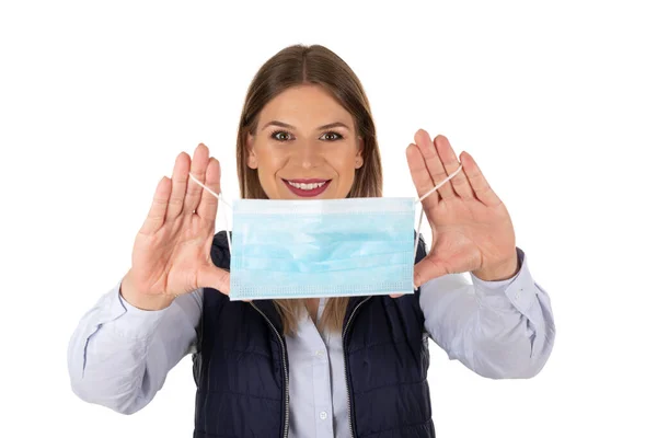 Smiling Young Woman Isolated Background Holding Surgical Mask — Stock Photo, Image