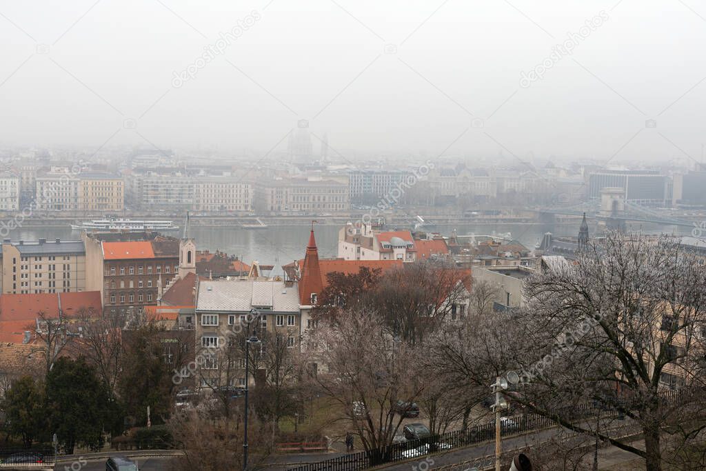 Panoramic picture of Budapest downtown and the Danube river and a bridge on a foggy winter day