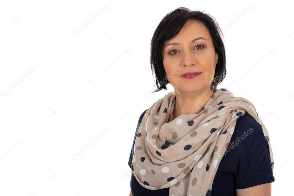 Portrait of charming middle aged woman with elegant scarf on isolated background