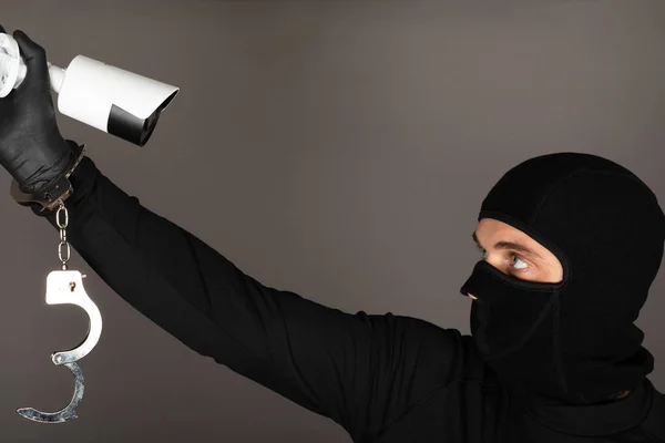 Siyah Maskeli Bir Hırsızın Fotoğrafı Güvenlik Kamerasını Kapatmaya Çalışıyor — Stok fotoğraf