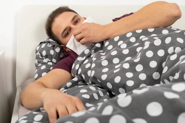 Young Man Seasonal Influenza Lying Bed Home Blowing His Nose — Stock Photo, Image