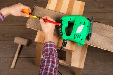 Zanaatkar yeni daireye kaplama döşeme kuruyor