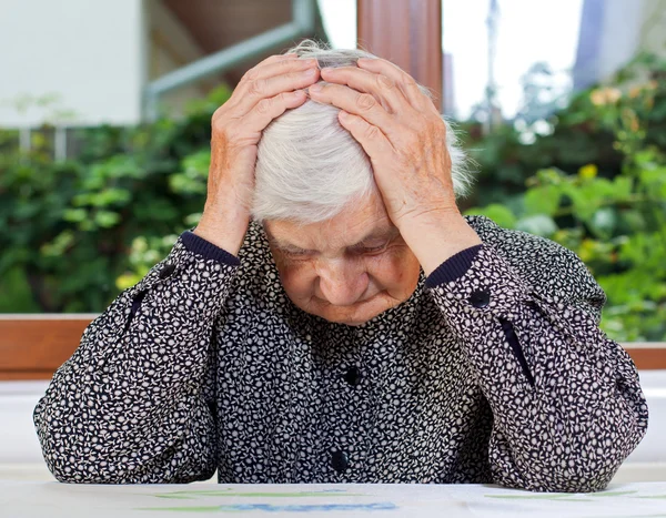 Unhappy elderly woman — Stock Photo, Image