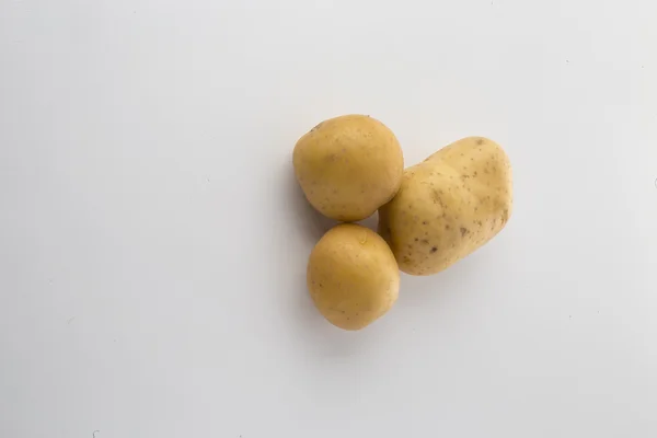 Three potatoes on white — Stock Photo, Image