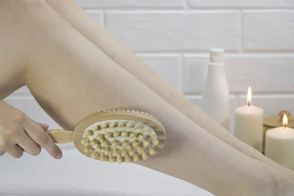 Preparing the skin for epilation. Exfoliation with a natural bristle brush. Dry brush massage. Strawberry legs, keratosis. Home skin and body care. SPA. Hairy legs. Beautiful slim female legs.