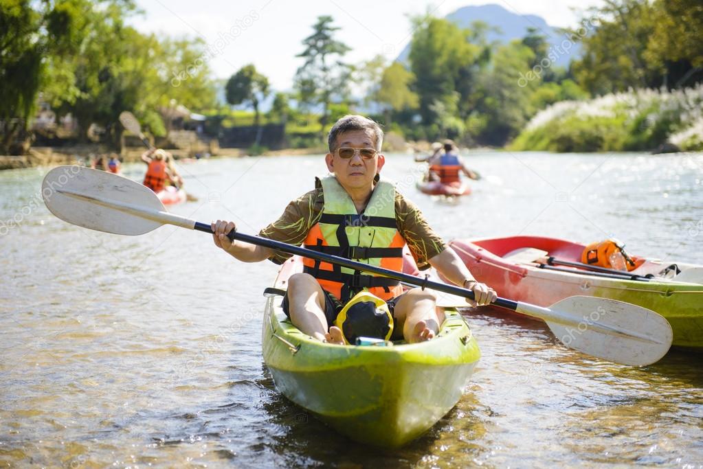 Senior man paddling kayak