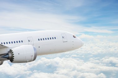 Airplane over clouds clipart