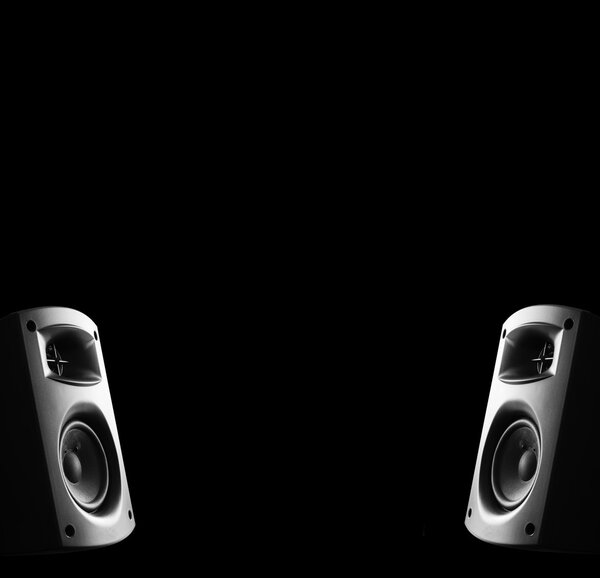 Two way modern music speakers. Isolated on black background.