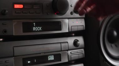 4K Hand CD 'yi oynatıcıya yerleştiriyor ve sesi açıyor