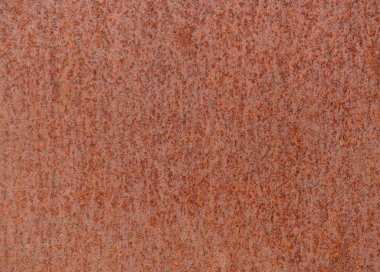 Turuncu kahverengi desenli paslı metal bir yüzey.