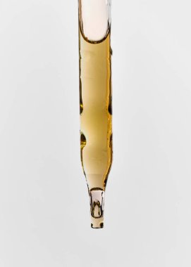 pipette with oil on a white background clipart