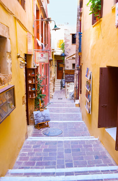 CHANIA, GREECE - OCTOBER 14, 2013: The tiny Moschon street with small souvenir stalls, cafes, hotels and art galleries, on Oct 14 in Chania