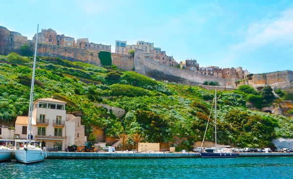 The medieval ramparts of Citadel and historic houses of old town from the harbor of Bonifacio, Corsica, France