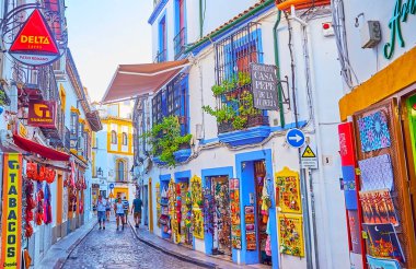 CORDOBA, SPAIN - SEP 30, 2019: The colorful souvenir stores and art galleries of the Juderia tourist market, Calle Romero street, on Sep 30 in Cordoba clipart