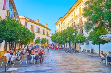 CORDOBA, SPAIN - SEPTEMBER 30, 2019: Plaza Agrupacion de Cofradias square is a nice place to relax and spend time in local outdoor cafe, on September 30 in Cordoba clipart