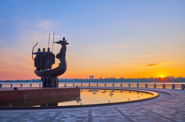 The first minutes of sunrise above the Dnieper River with a view of City Founder Monument in the foreground, Pechersk, Kyiv, Ukraine