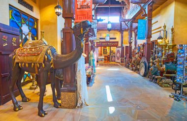 DUBAI, UAE - MARCH 4, 2020: The camel sculpture attracts the tourist to visit a stall of Souk Madinat Jumeirah market, on March 4 in Dubai