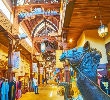 DUBAI, UAE - MARCH 4, 2020: The sculptures of camels decorate the entrance to the stall of Souk Madinat Jumeirah market, on March 4 in Dubai