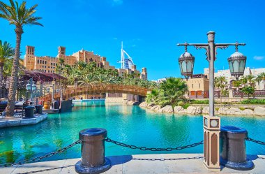 Souk Madinat Jumeirah market has a canal with a pedestrian bridge, Fort Island, cafes and boasts the view on Burj Al Arab, Dubai, UAE