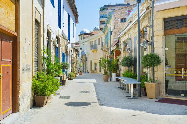 The streets of the old town decorated with plants in pots and colorful signboards, Limassol, Cyprus.