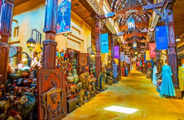 DUBAI, UAE - MARCH 4, 2020: Interior of Souk Madinat Jumeirah market with many souvenir stalls and antique store, full of sculptures, statuettes, masks, dolls, souvenirs, on March 4 in Dubai